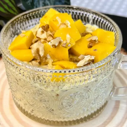 Creamy mango overnight oats in a jar topped with chia seeds
