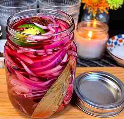 Jar of quick pickled red onions with pink brine