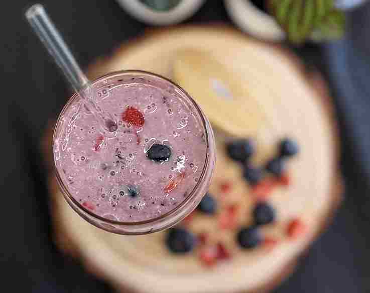 Berry almond smoothie with strawberries, blueberries, almonds, chia seeds, and almond milk